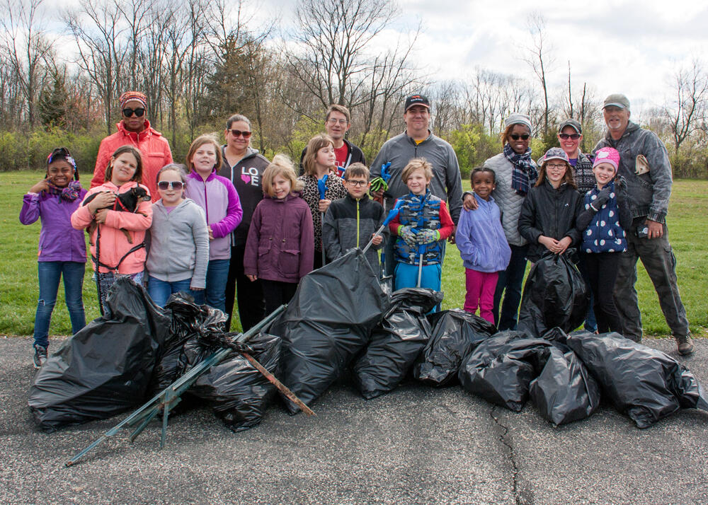 Group standing on newly built bridge over stream crossing
